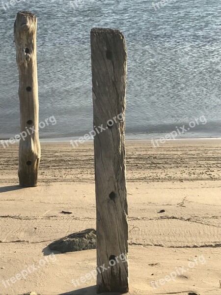 Water Calm Wood Posts Sand