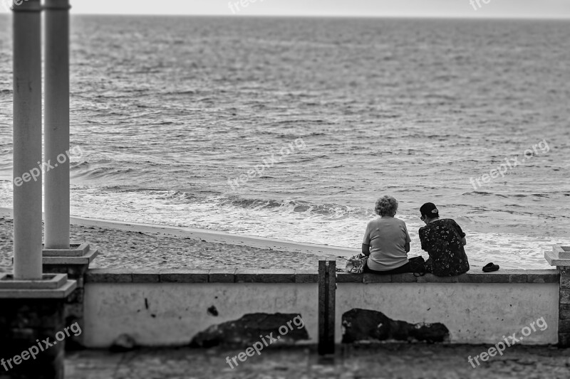 Women Seashore Sitting Chatting Ocean