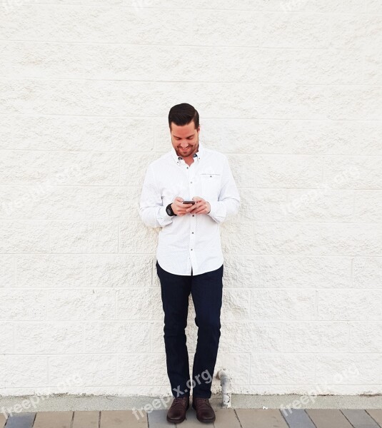 Young Man Looking At Phone Brick Wall White Wall Mobile