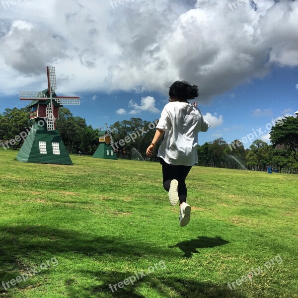 Blue Sky And White Clouds Grassland Jumping Windmill Happy