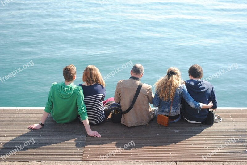 Group Sitting By Water People By Water Group People Water