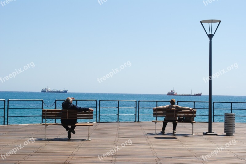 Looking At Ships Sitting On Dock Sitting Benches Outdoors