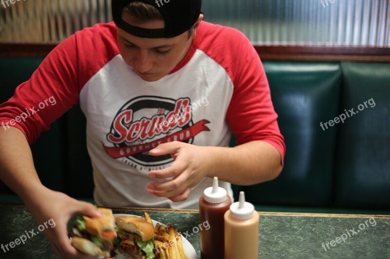 Fast Food Man Eating Burger Inside