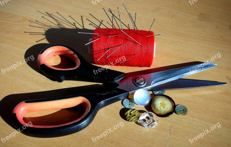 Scissors Sewing Coil Buttons On The Table