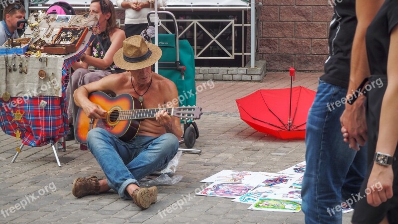 Playing Guitar Man Sitting On The Pavement Sale Of Souvenirs Free Photos