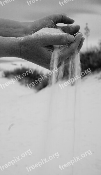 Black And White Sand Runs Through Sand Fingers White Sand